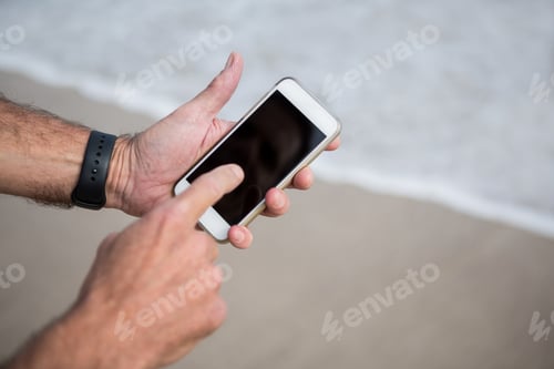 Preview: Close-up of mans hands using mobile phone