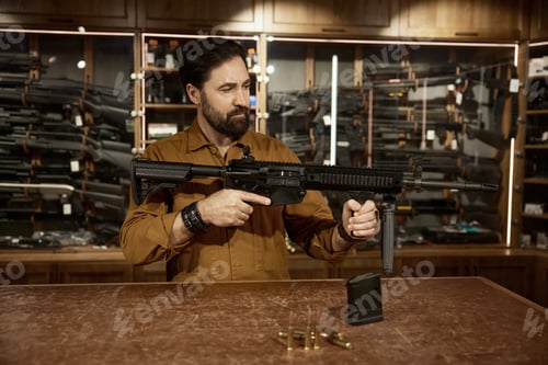 Preview: Salesman presenting new model of military gun standing at counter desk