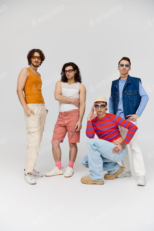 Preview: four handsome cheerful gay friends with stylish sunglasses posing actively together, pride month