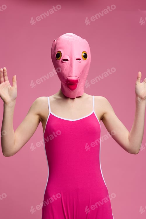 Preview: Very strange woman in a pink silicone fish mask for Halloween, crazy image in pink clothes
