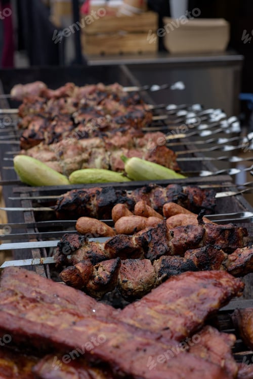 Preview: Grilled skewers of meat on the coals, with smoke. street food.