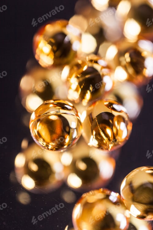 Preview: orange capsules on mirror background