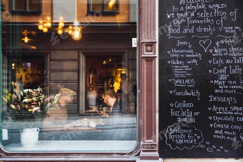 Preview: Sweden, Stockholm, Gamla Stan, Two men having coffee, seen through coffee shop window