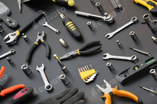 Preview: Handyman tool kit on black wooden table. Many wrenches and screwdrivers