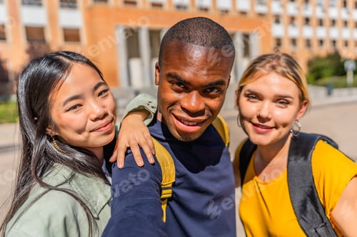 Preview: African man taking selfie with university colleagues at campus