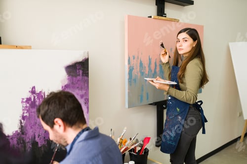 Preview: Rear View Of A Pretty Woman In Her 20S Making Eye Contact And Holding A Brush. Young Woman Standing