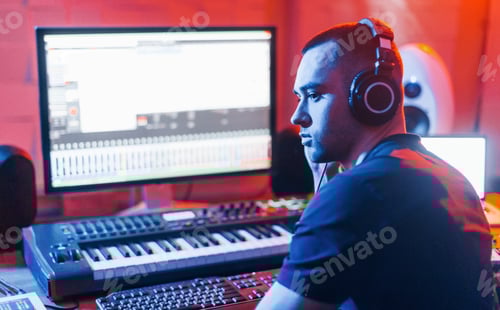 Preview: Sound engineer working and mixing music indoors in the studio near drum kit
