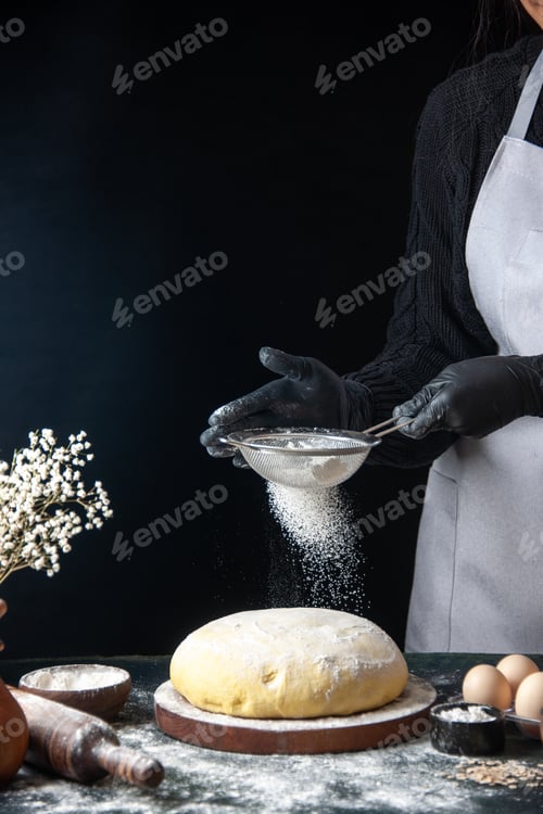 Preview: front view female cook pouring white flour on raw dough on dark background pastry job raw dough