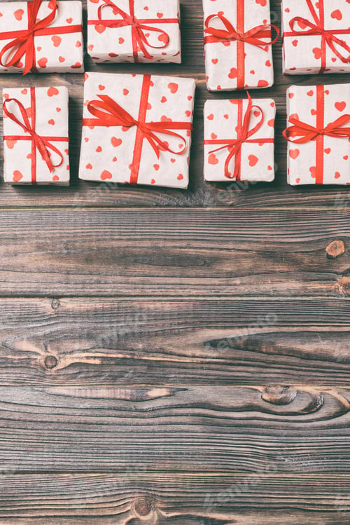 Preview: valentine or other holidays concept. Lots of Gift boxes on wood background top view.