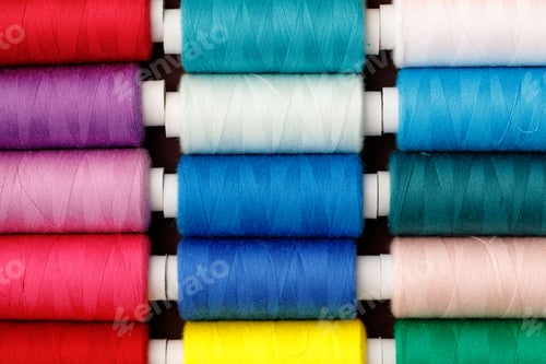 Preview: Close up of colored thread coils, thread spools background