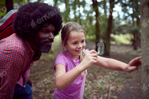 Preview: Girl With Male Team Leader At Outdoor Activity Camp Studying Tree Bark With Magnifying Glass
