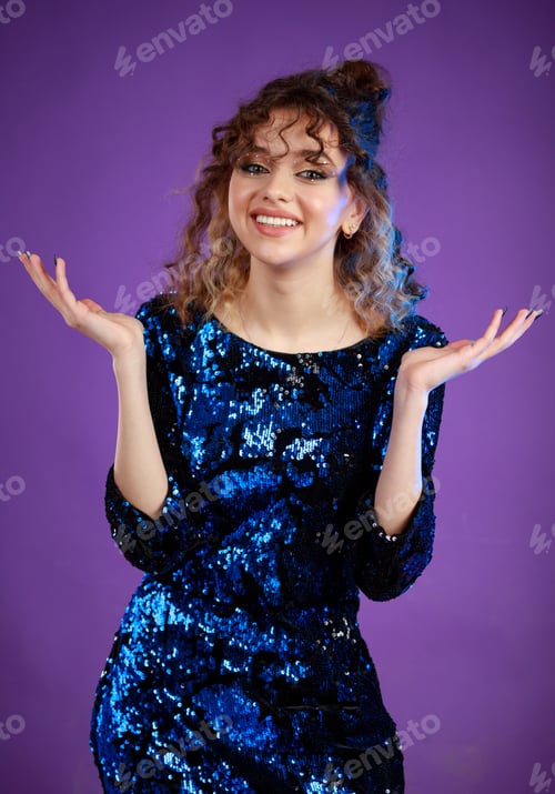 Preview: A vertical portrait of a curly-haired girl opens her hands wide and laughing.