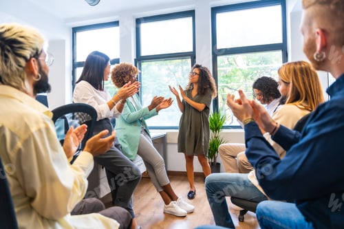 Preview: Colleagues congratulating an african woman in a coworking