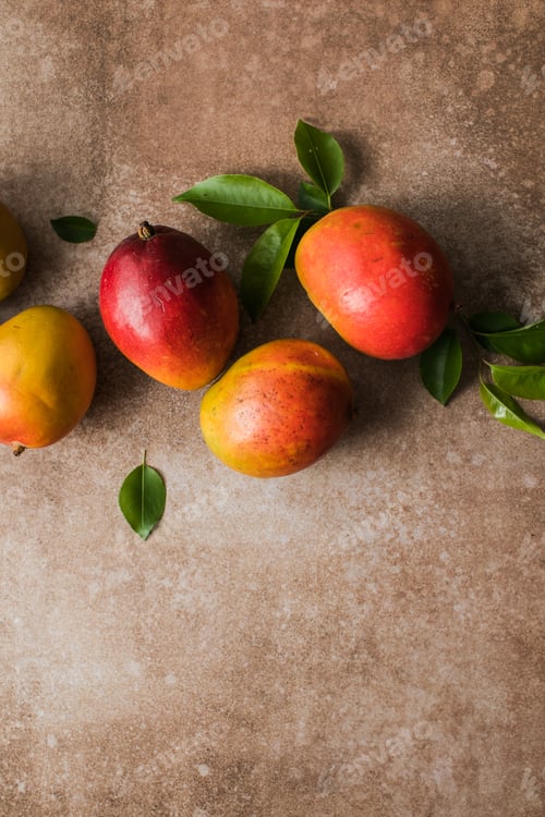 Preview: Mango background design concept. Top view of fresh mango fruit pattern with leaves on table.