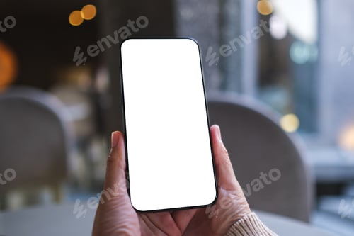 Preview: Mockup image of a woman holding and using mobile phone with blank desktop screen in cafe