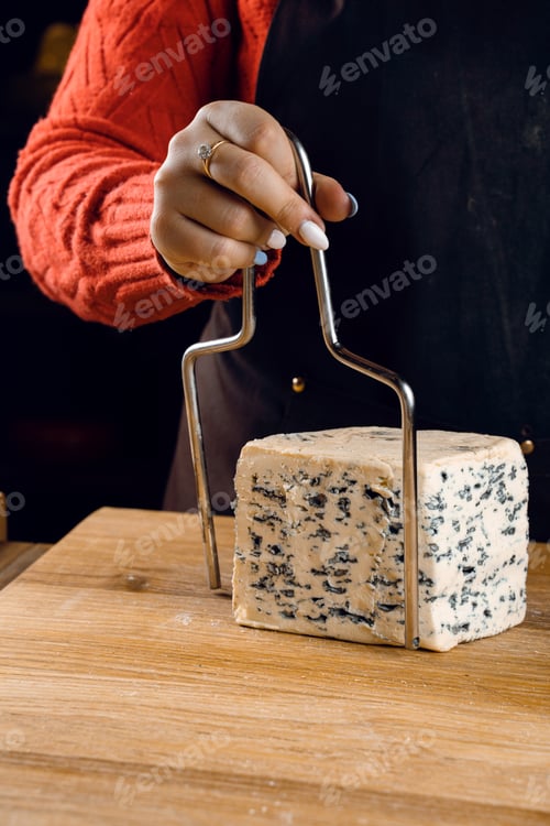 Preview: String slicing soft blue cheeses for a gourmet French plate