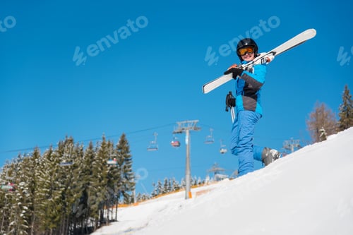 Preview: Skier resting on top of the mountain