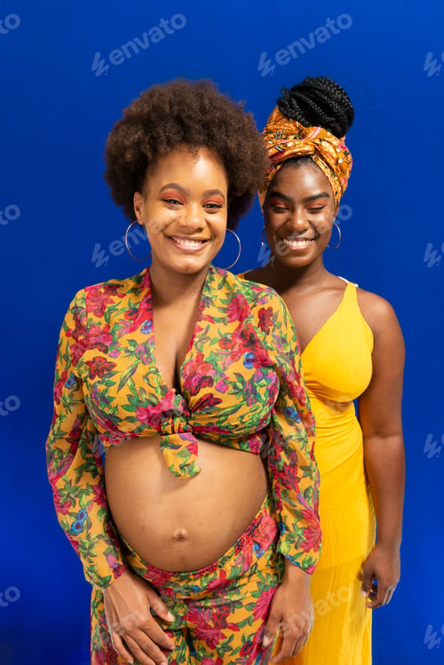 Preview: Portrait of two women against blue background.