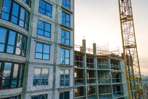 Preview: Aerial view of high tower crane and residential apartment buildings