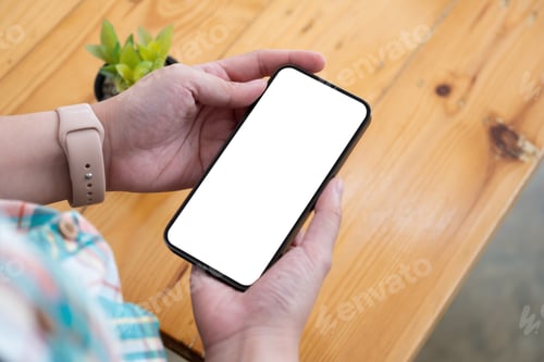 Preview: Top view Woman sitting and holding blank screen mock up mobile phone,
