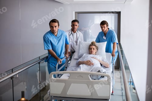 Preview: Team of doctors taking a pregnant woman to operation theatre