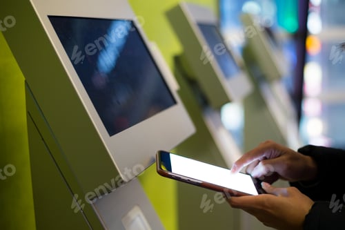 Preview: Woman using mobile phone for paying on vending system