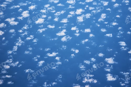 Preview: Blue cloudy sky, view from the airplane window. Aerial view of cloudscape, abstract background
