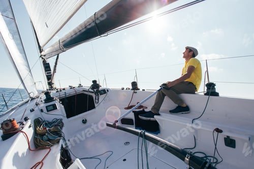 Preview: Captain or sailor of sailboat steers yacht in wind