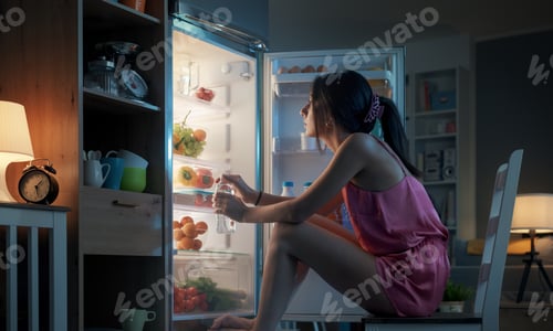 Preview: Woman cooling herself in front of the open fridge