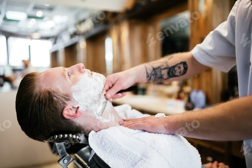 Preview: Man Having a Straight Razor Shave at Barbershop