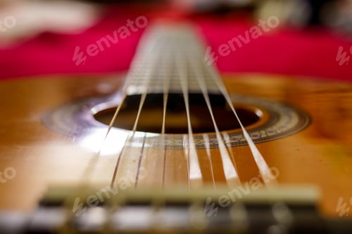Preview: An acoustic guitar over a red bed