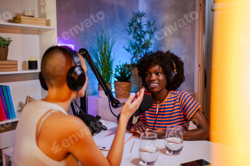 Preview: A podcaster is interviewing and hosting a guest in a home recording studio.