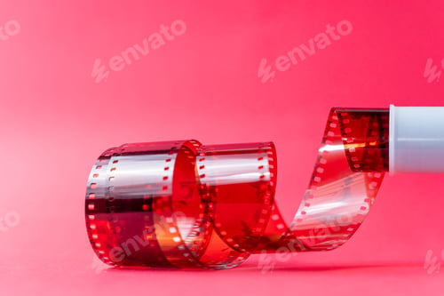 Preview: Red Film Strip Unwinding on Pink Background