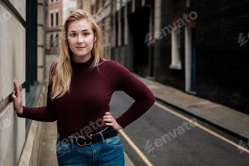 Preview: Portrait of young woman posing in a very narrow street.