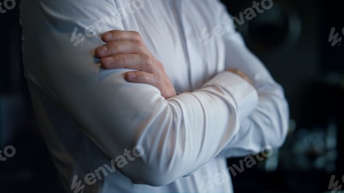 Preview: Unknown businessman standing dark restaurant interior. Closeup folded man hands