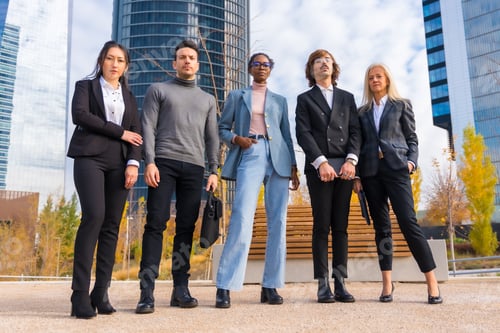 Preview: Corporate portrait of group of multi-ethnic businessmen and businesswomen outside offices