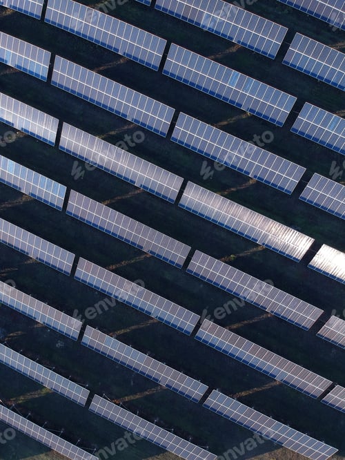 Preview: Aerial photo of solar power plant. Many solar energy panels in countryside from above