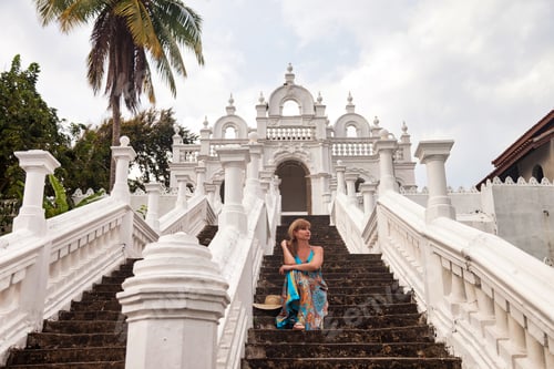 Preview: Traveler Enjoys Peace at a Serene Buddhist Temple During Summer Holidays in Tropical Surroundings