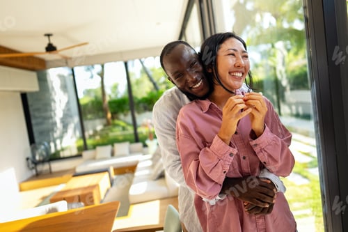 Preview: Young diverse multiethnic couple moving in new home. Couple is having fun in new house at moving day
