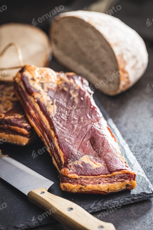 Preview: Whole smoked bacon on cutting board.