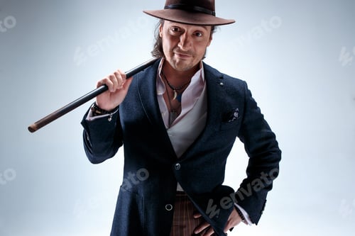 Preview: The Mature Man In A Suit And Hat Holding Cane.
