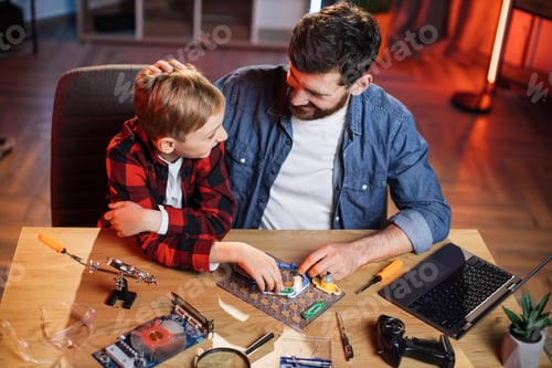 Preview: Dad with son doing electric circuit experiment at home