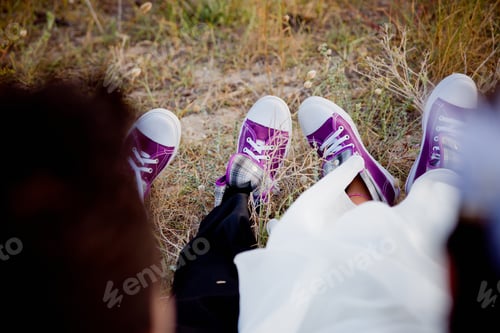 Preview: Feet of a bride with sneakers in a forest, strange romantic image.