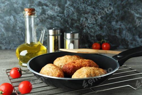 Preview: Concept of tasty food with cutlets on gray textured table