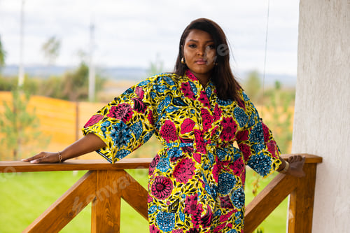 Preview: Beautiful african american woman enjoying evening on village and nature on terrace of country house