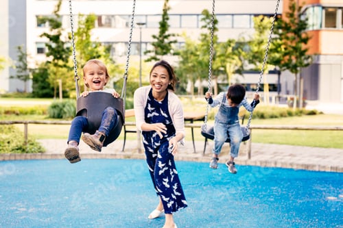 Preview: Joyful moments as a mother pushes her child on a swing at the playground