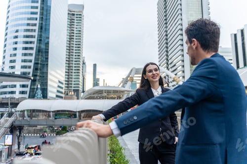 Preview: Caucasian businessman and businesswoman talking outdoors in the city.