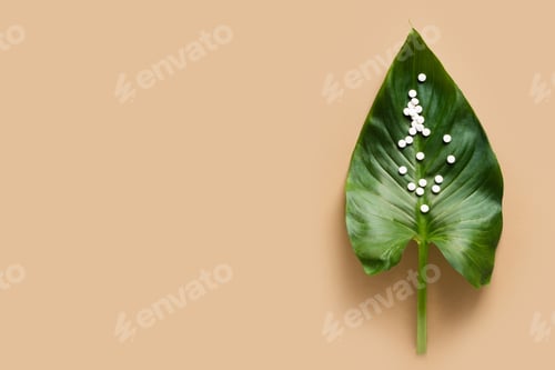 Preview: Tablet or pill on the green leaf close up. Natural treatment concept antivirus