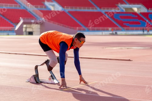 Preview: Asian para-athletes with prosthetic blades sprint on a running track at stadium.