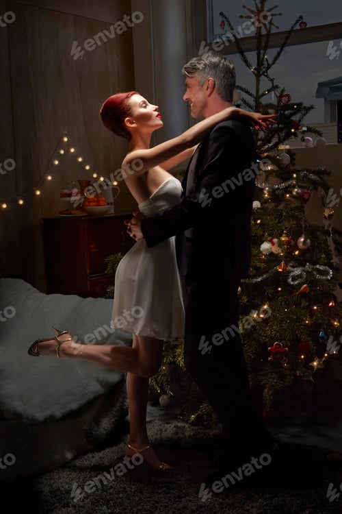 Preview: Husband and wife dancing by Christmas tree